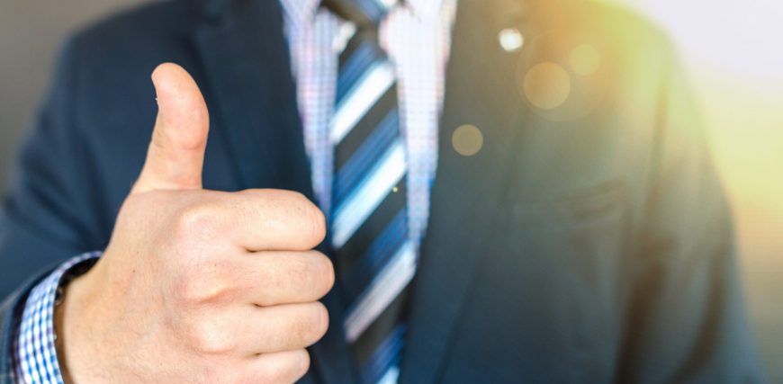 close-up-photo-of-man-wearing-black-suit-jacket-doing-thumbs-684385